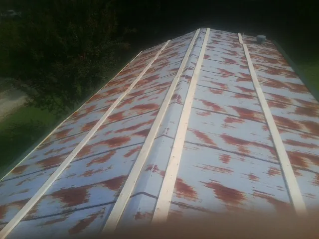Rusted metal roof panels with new wood purlins before replacement — Storm Damage Roof Repair in Middlefield by Roofing Brothers